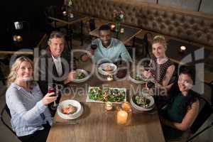 Overhead of happy friends dining together