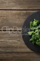 Cropped image of kale on plate over table
