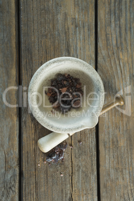 Black salt in mortar on wooden table