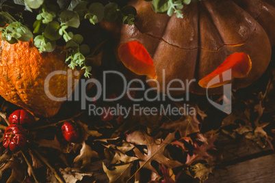 High angle view of jack o lantern with autumn leaves during Halloween