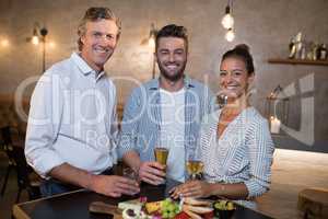Portrait of happy friends having drinks and meal