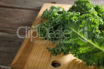 Kale leaves on wooden cutting board
