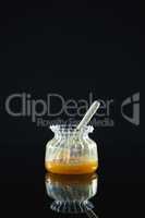 Honey dipper in glass jar