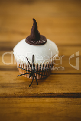 Close up of cup cake with spider and witch hat