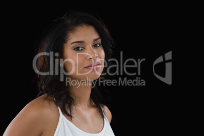 Woman standing against black background