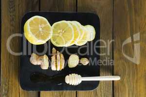 Lime, garlic and honey dipper in black slate plate