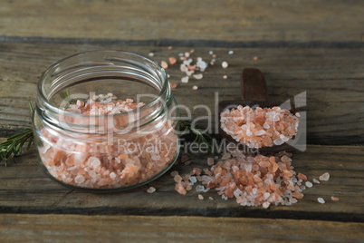 Himalayan salt and rosemary on wooden table