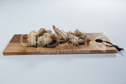 Close up of fresh gingers on wooden serving board