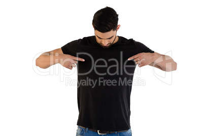 Handsome man pointing at t-shirt