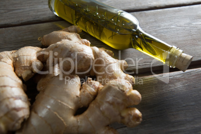 Close-up of gingers with oil bottle