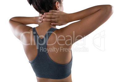 Female athlete massaging neck