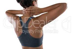 Female athlete massaging neck