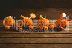 Jack o lantern containers with food arranged on table