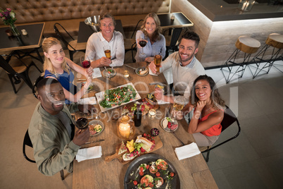 Overhead of happy friends dining together