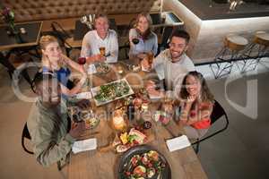 Overhead of happy friends dining together