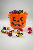 Orange bucket with colorful wrapped chocolates