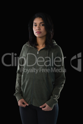 Portrait of female athlete in hooded jacket