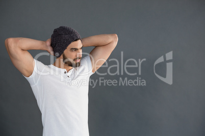 Handsome man standing with hands behind back