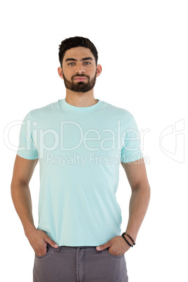 Handsome man posing with hands in pocket against white background