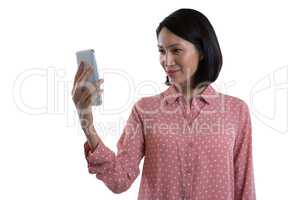 Female executive taking selfie with mobile phone