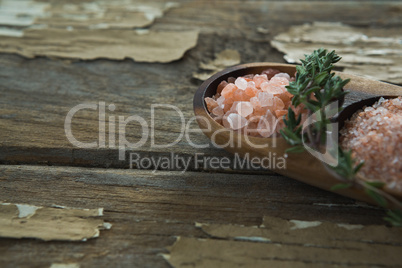 Himalayan salt with rosemary in wooden bowl