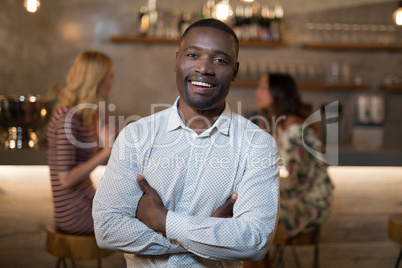 Portrait of happy standing with arms crossed