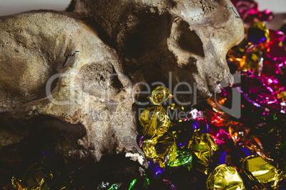 Close up of skull with wrapped chocolates