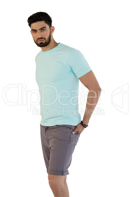 Handsome man posing with hands in pocket against white background