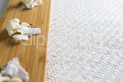 Cauliflowers with cheese on cutting board