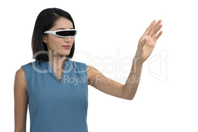 Female executive gesturing while using virtual reality headset