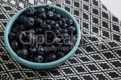 Blueberries in bowl on a textile