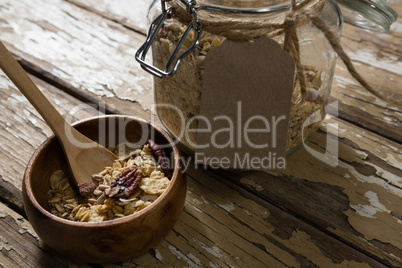 Bowl of breakfast cereals with jar