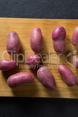 Overhead view of sweet potatoes arranged on cutting board