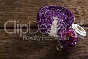 Chopped and halved red cabbage on wooden table