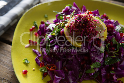 Salad in plate on wooden table