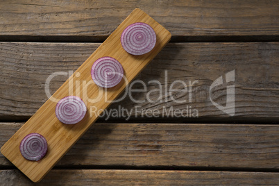 Sliced onions on a wooden tray