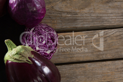 Red cabbage and eggplant on wooden table