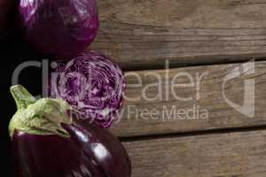Red cabbage and eggplant on wooden table