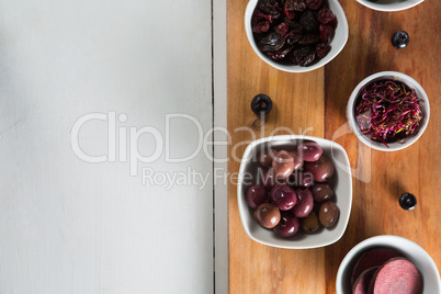 Overhead view of beetroot slice with various fruits in bowls