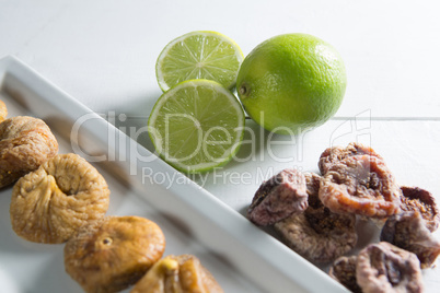 Close-up of figs with lemons in plate