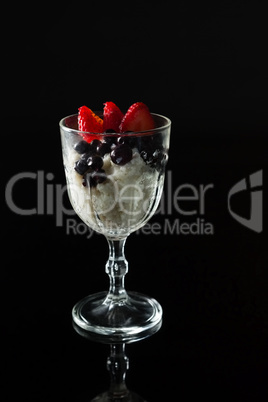 Glass of yogurt, black cherries and strawberries for breakfast