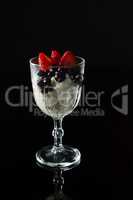 Glass of yogurt, black cherries and strawberries for breakfast