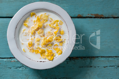 Breakfast cereals in bowl on wooden table