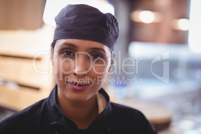 Close-up portrait of confident young waitress