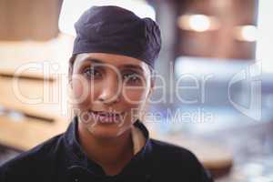 Close-up portrait of confident young waitress