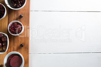 Overhead view of olives with various fruits in bowls