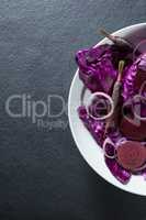 High angle view of vegetables in plate on slate