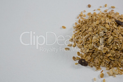 Crunchy granola scattered on white background