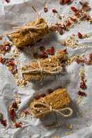 Granola bars tied with string on wax paper