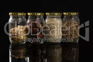 Dried fruits and breakfast cereals in glass jar